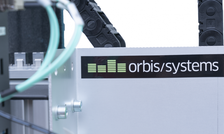 Orbis Systems' logo on a customized positioner solution.